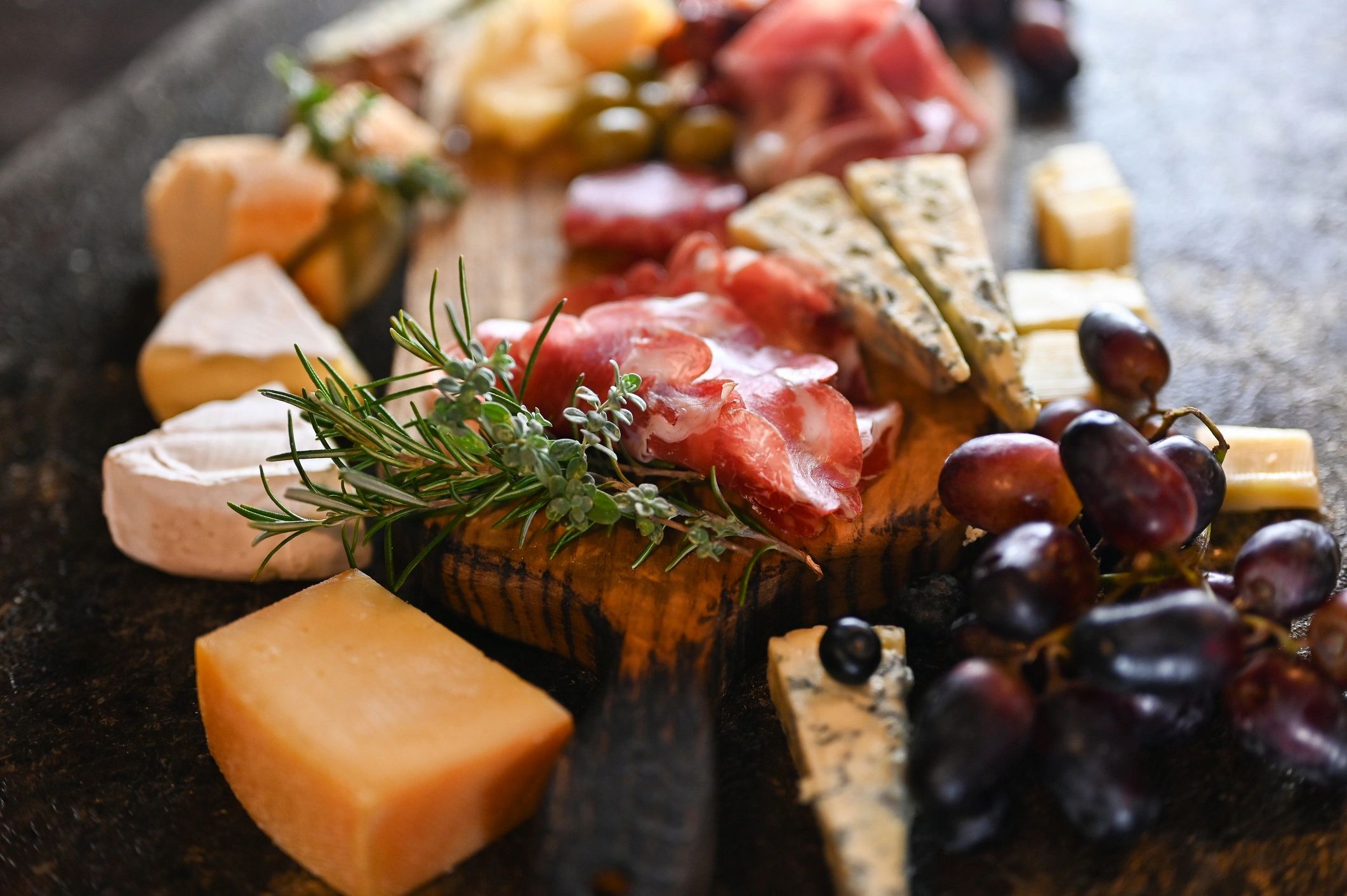 Artisan charcuterie platter with cheeses, fruit, and cured meats